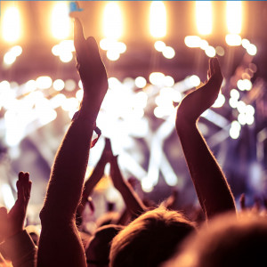 Best Events and Entertainment - stage lights and audience clapping in a concert