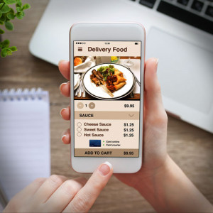 A person ordering food in a cell phone application for a food delivery service