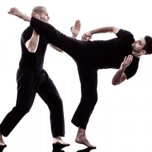 Two men in an all black attire demonstrating a Krav Maga technique