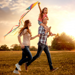 Best Family Parks and Outdoor attractions - Family with a little girl holding a kite strolling