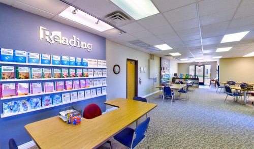 Reading section of Tutoring Club - Green Valley Pkwy, Henderson, NV with textbooks on display behind the study table