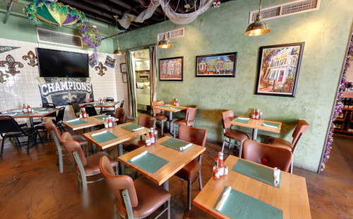 Las Vegas Multiple tables & chairs arranged in the dining area of Lola's - Southern American restaurant in Vegas serving Cajun-Creole specialties