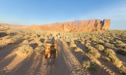 Las Vegas Valley of Fire State Park hiking attraction in Nevada - Fire wave's vast walking trail towards the huge rock formation