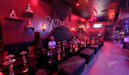 Dark & Egyptian inspired lounge with a couple of patrons inside a hookah bar in Las Vegas - Azuza Hookah Lounge & Cafe