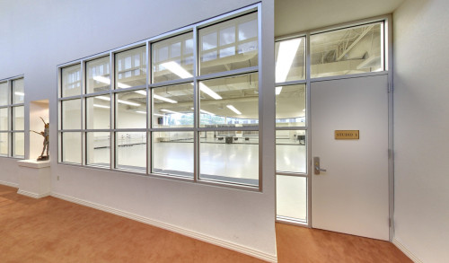 undefined Huge, brightly lit dance studio can be seen from its square-shaped, transparent glass windows inside Nevada Ballet Theatre