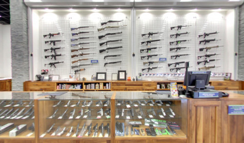 Firearms & shooting equipments displayed on the wall & glass counter inside The Range 702 - the largest indoor shooting range in Nevada