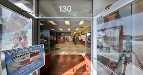 Las Vegas Service desk and glass doored cabinets with several eyeglasses displayed inside Custom Eyes clinic in Henderson, Nevada