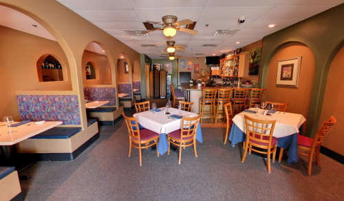 An arched walkway along the dining area facing the bar area of Todd's Unique Dining - steak & seafood restaurant in Henderson, Nevada