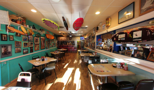 Colorful surfboards, several pictures & other memorabilias, along with the rows of metal chairs & dining tables adorned the interiors of The Coffee Cup Cafe, serving breakfast & lunch in Boulder City, NV