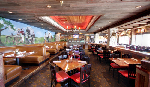 Las Vegas Waiting lounge at the entrance of Texas-themed restaurant, Saltgrass Steak House in their Laughlin, NV location with its signage shining in red light