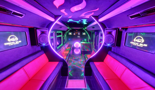 Bright, colorful neon lights, long cushioned seats, speakers and a dance pole inside one of DiscoBus Las Vegas' limousine service, perfect for night outs, parties or events