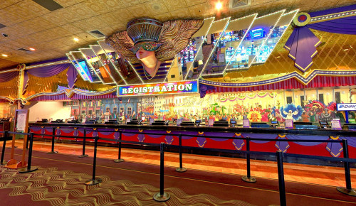 Las Vegas Mirrored glass wall & entrance door of The Orleans Hotel & Casino & a glod plated sign "The Orleans" decorates the concrete floor