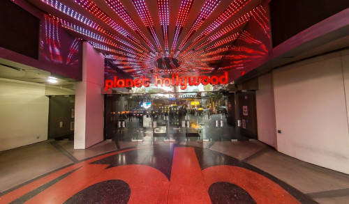 Planet Hollywood Resort and Casino in Las Vegas with shining red led lights above its mirrored glass entrance doors